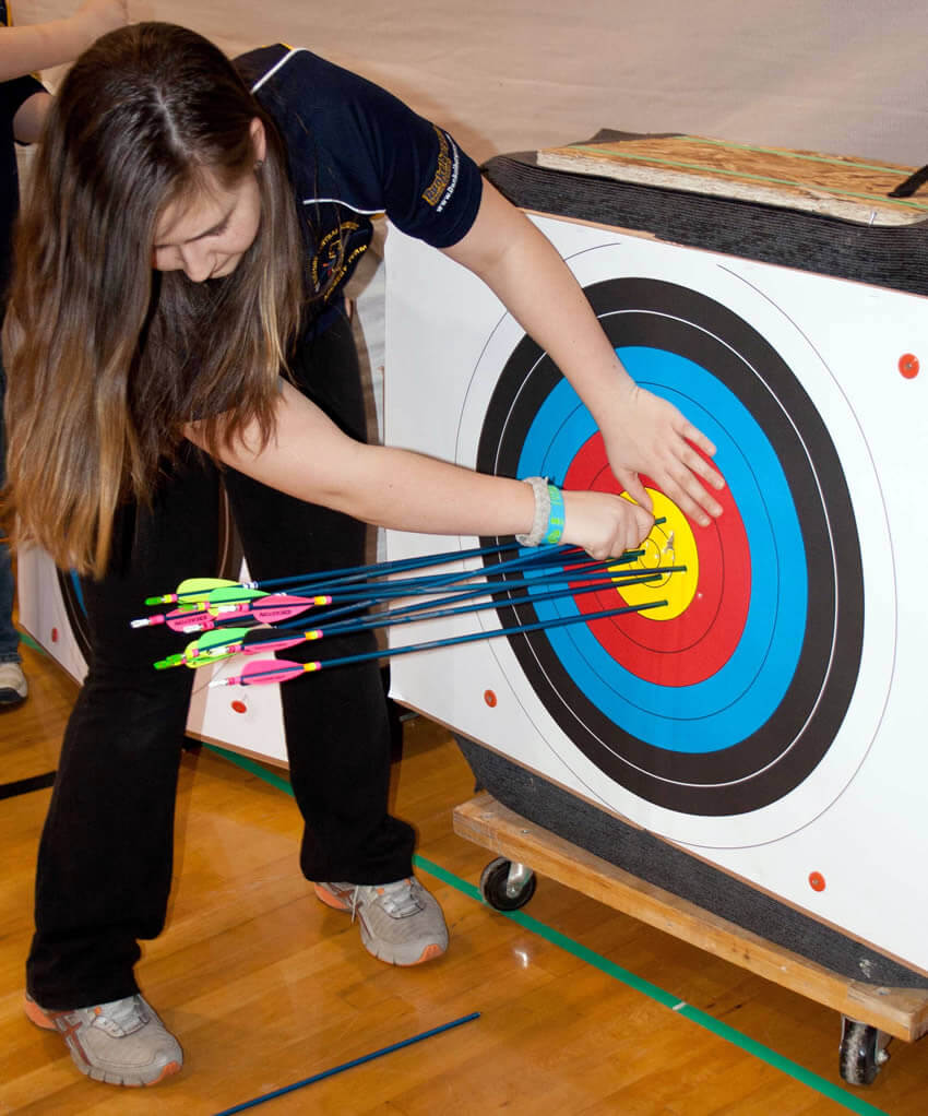 Archer removing arrows from target