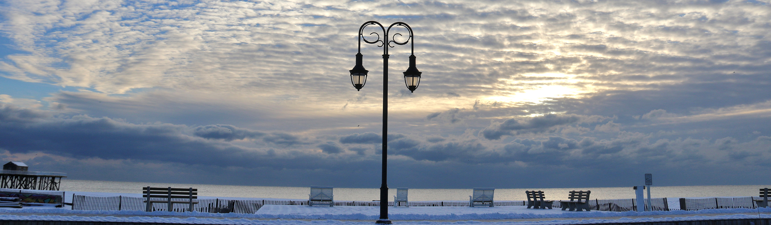 winter in belmar, snow on beach with lamp post
