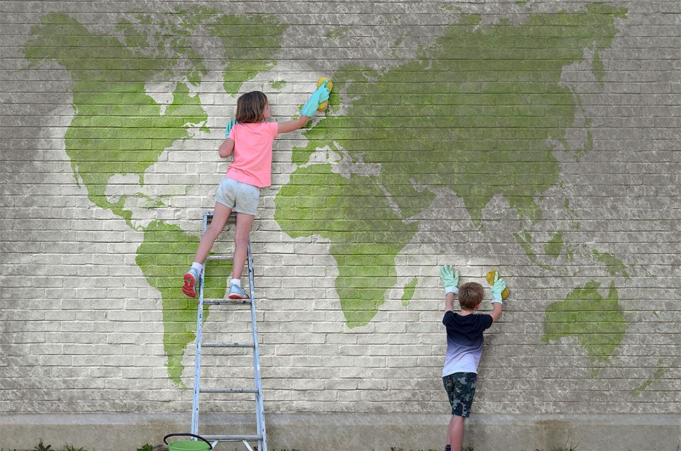 Photo of children cleaning a painting of a map