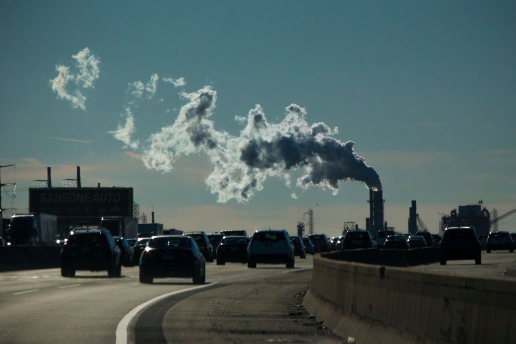 Industrial smoke is emitted into the sky over vehicles moving along the New Jersey Turnpike in Carteret.