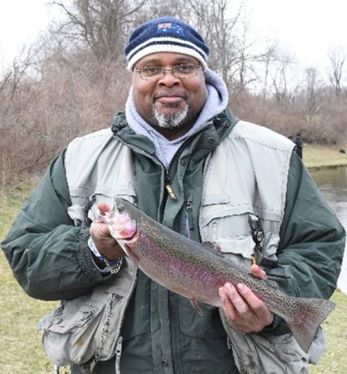 Fisherman holding a rainbow trout