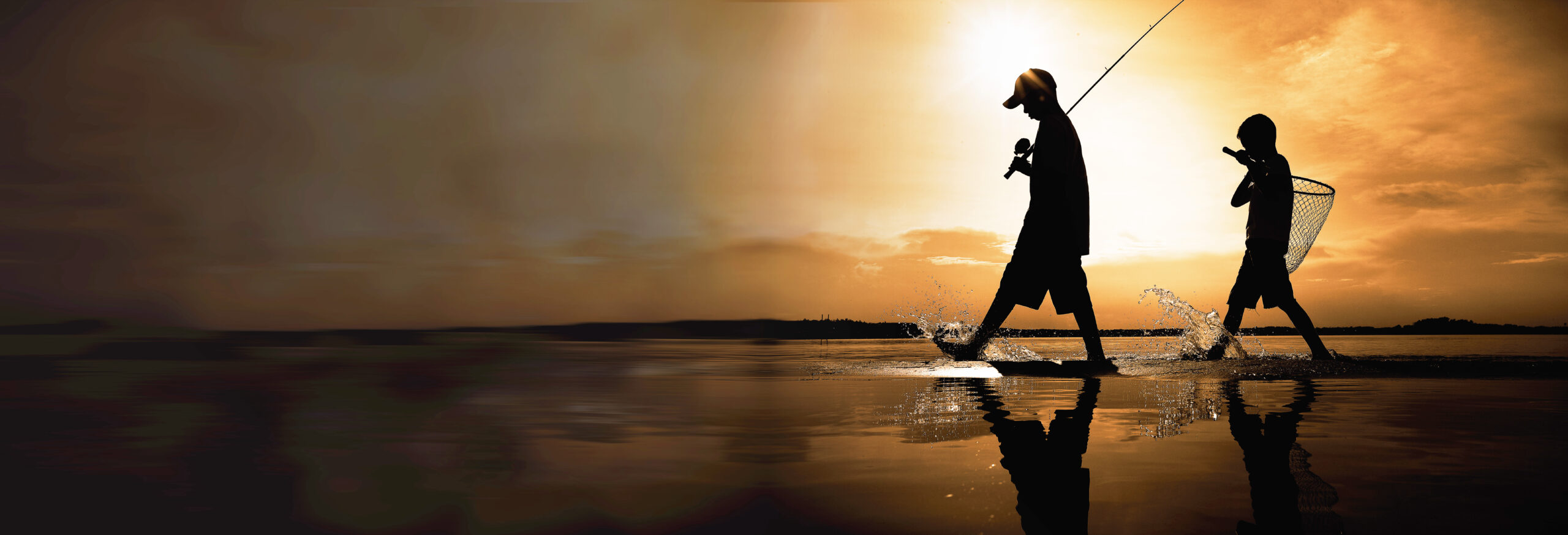 A fisherman silhouette fishing at sunset. Freshwater fishing