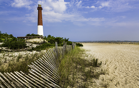 picture of red and white lighthouse on beach